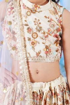 Cream lehenga featuring floral thread and sequin embroidery with handmade tassels. Paired with a matching embroidered blouse with lace detailing and a dupatta. - Aza Fashions Sleeveless Lehenga With Floral Embroidery For Eid, Festive Choli With Floral Embroidery And Traditional Drape, Festive Choli With Floral Embroidery, Floral Embroidered Choli With Traditional Drape For Festive Occasions, Festive Choli With Floral Embroidery In Traditional Drape, Sleeveless Floral Embroidered Choli For Eid, Sleeveless Floral Embroidery Choli For Eid, Choli With Floral Embroidery And Traditional Drape For Festivals, Floral Embroidered Choli With Traditional Drape For Festivals