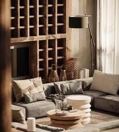 a living room filled with lots of furniture next to a wall mounted book shelf and window