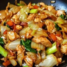 chicken and vegetable stir fry in a wok