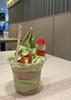 a dessert in a bowl with strawberries and ice cream