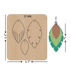 a pair of wooden earrings with leaves on them