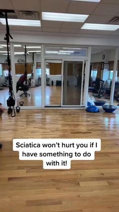 an empty gym room with exercise equipment on the floor and a quote about squatting