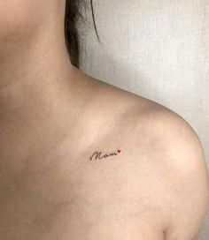 a woman's chest with the word mom tattooed on her left side ribcage