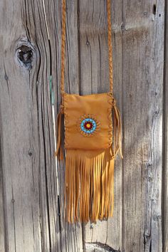 This crossbody bag is made of saddle tan leather and has a 48 inch braided strap that can also be tied around the waist  as a hip bag. The beaded sunflower rosette makes this bag stand out. Measurements are 5 3/4" tall x 4 1/4" wide.  This item is MADE TO ORDER. You will not receive the piece you see in the photos, we will make one similar for you. Please allow 3 to 4 weeks to ship and take the time to read our shop policies about MADE TO ORDER items. http://www.etsy.com/shop/thunderrose/policy? Adjustable Brown Shoulder Bag For Festival, Festival Shoulder Bag With Cell Phone Pocket, Handmade Adjustable Crossbody Bag, Bohemian Shoulder Bag With Cell Phone Pocket, Brown Beaded Shoulder Bag For Everyday Use, Bohemian Crossbody Shoulder Bag With Cell Phone Pocket, Adjustable Crossbody Festival Bags, Bohemian Shoulder Bag With Cell Phone Pocket As Gift, Festival Crossbody Mobile Phone Bag