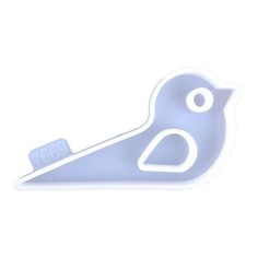 a blue bird shaped object sitting on top of a white surface