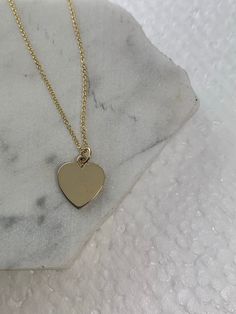 "This sweet and simple Gold heart pendant can be engraved on both sides.  - 14K Solid Gold  - Available in Rose Gold, Yellow Gold, White  Gold  - Gold Heart Measures 12MM height / 11MM wide  - Adjustable Length: 14\" - 15\" - 16\"  All our materials and jewelry are sourced ethically and responsibly.  Our jewelry is complimentary gift wrapped in our signature Willow Roe boxes." Classic 14k Gold Heart Pendant Necklace, Classic 14k Gold Heart Necklace, Everyday Yellow Gold Heart Cut Charm Necklace, Heart-shaped Yellow Gold Charm Necklace In Sterling Silver, 14k Gold Charm Necklace With Heart Pendant, Yellow Gold Heart Charm Necklace In Sterling Silver, Sterling Silver Charm Necklace With Heart Pendant, 14k Gold Heart Charm Necklace With Round Pendant, 14k Gold Heart Charm Necklace For Her