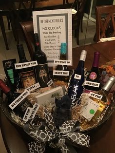 a wine gift basket filled with bottles of wine, liquor and other items for retirement