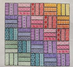 a cross stitch pattern with different colored squares