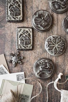 some cookies are sitting on a table next to string and paper tags, with other items in the background