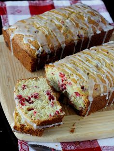 a sliced loaf of cranberry bread on a cutting board