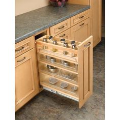 an open cabinet in a kitchen with pots and pans on the bottom shelf,