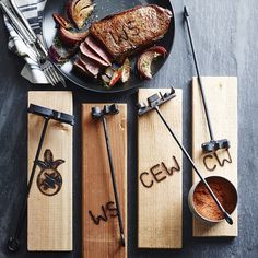 wooden chopsticks with the words cel on them and some meat next to it