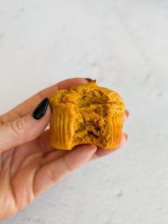 a person holding a muffin in their hand