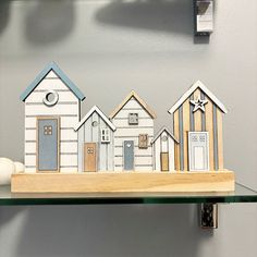 a shelf with some cut out houses on it