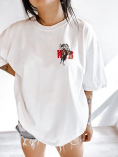 These tees are printed on super soft Comfort Colors, providing a relaxed unisex fit with a worn-in look and feel. This collection offers our most expanded size range from S-3X.Looking for these tees to fit oversized? Size up 1-2 sizes.Model has sized up to an XL for an oversized fit.• 100% ring-spun cotton• Garment-dyed• Relaxed fitThis product is made especially for you as soon as you place an order, please see the banner on the top of our site for current turnaround times. Making products on d Graphic Tee With White Print And Crew Neck, White Trendy T-shirt With Back Print, Trendy White T-shirt With Back Print, Cotton Graphic Tee With Back Print, Graphic Cotton Tee With Back Print, Graphic Tee Cotton Shirt With Back Print, Relaxed Fit White Graphic Tee, White Graphic Tee In Relaxed Fit, White Print Cotton T-shirt With Back Print