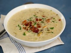 a white bowl filled with soup on top of a blue table