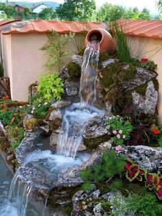 a small waterfall in the middle of a garden