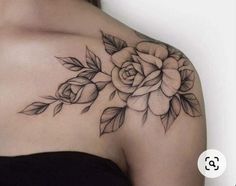 a woman's shoulder with a rose tattoo on it