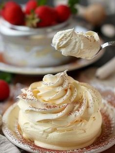 a close up of a cake on a plate with a spoon