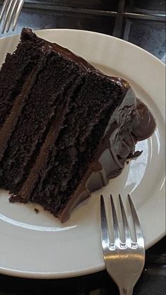 a slice of chocolate cake on a white plate