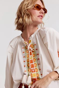 Our best-selling Minka Shirt has intricate embroidery in rich colors of the season. Loose, blousy, and in our crisp poplin.

 Rochelle Behrens reimagined how shirts should fit and feel. Our patented No Gape® button technology, seamlessly designed into every shirt and shirtdress we design, eliminates blouse gape. Finally say bye-bye blouse gape, and hello to The Shirt.

  
 * Imported 
 * 100% Cotton Spring Embroidered Orange Blouse, Orange Embroidered Cotton Blouse, Orange Long Sleeve Blouse With Floral Embroidery, Orange Cotton Blouse With Floral Embroidery, Long Sleeve Orange Top With Floral Embroidery, Casual Orange Embroidered Blouse, Orange Floral Embroidered Long Sleeve Top, Embroidered Blouse For Daywear In Fall, Orange Fall Tops For Daywear