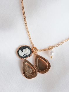 "The little delicate locket etched with a floral pattern, accompanied by a vintage olive green cameo. A teeny tiny pearl adds the perfect touch of sweetness to this precious little necklace. Subtle and feminine. Available in jet black, baby pink, olive green and periwinkle blue. MATERIALS 18k gold plated chain, tarnish resistant 22k gold plated brass locket/charms, Swarovski pearl, vintage cameo DIMENSIONS 16\" (40cm) length, 2\" extender chain. Charm pendant measures 3/4\" (2cm) ◊ More delicate Dainty Rose Gold Pendant Locket Necklace, Dainty Brass Locket Charm Necklace, Dainty Medallion Charm Necklace As Keepsake, Delicate Vintage Charm Jewelry Gift, Delicate Vintage Charm Jewelry As A Gift, Delicate Vintage Charm Jewelry For Gift, Dainty Pendant Locket Necklace With Vintage Charm, Dainty Medallion Keepsake Jewelry, Delicate Vintage Charm Pendant Jewelry