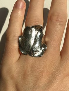 Absolutely stunning artisan made sterling silver leaf ring. Looks like an ivy leaf. Sits really flat against the finger. Surprisingly comfortable to wear. Shows minimal signs of wear. Perfect for a plant lover! Fits US ring size 6 1/4 Unique Rings With Lost Wax Casting As Gift, Nature-inspired Untreated Silver Rings, Unique Handmade Ring For Collectors, Unique Handmade Rings For Collectors, Unique Handmade Collectible Ring, Artistic Hand Cast Rings As Gifts, Artistic Hand Cast Rings For Gifts, Lover Fits, Silver Leaf Ring