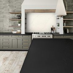 a kitchen with black counter tops and gray cabinets