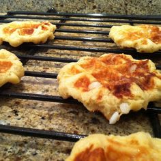 some food is cooking on a grill in the kitchen and it looks like they are going to be cooked