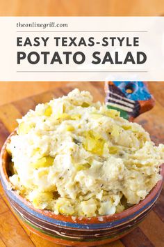 a bowl filled with potato salad on top of a wooden table