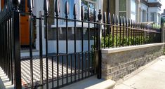 an iron fence is in front of a house