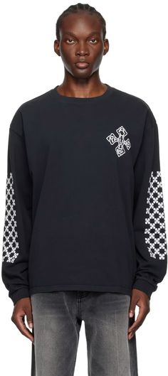 Rhude: Black Cross Long Sleeve T-Shirt | SSENSE Black Crew Neck T-shirt With Graphic Print, Black Graphic Print Crew T-shirt, Black Crew Neck Top With Back Print, Black Long Sleeve Top With Back Print, Urban Black T-shirt With Ribbed Cuffs, Black Cotton Sweatshirt With Back Print, Black T-shirt With Crew Neck And Ribbed Cuffs, Black Crew Neck Graphic Tee, Black Graphic Tee With Crew Neck