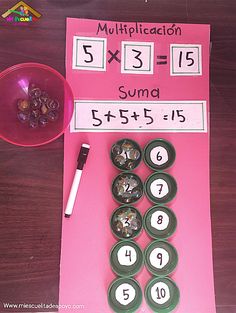 a pink paper with numbers on it and a pen next to it that says multiplicacion suma