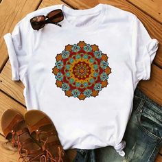 Embrace the timeless beauty of mandala art with our Versatile Mandala Art Tees. Crafted for comfort and style, these t-shirts feature intricate mandala designs that add a touch of casual elegance to your everyday wardrobe. Available in classic black and pristine white, these tops are perfect for those who appreciate the blend of art and fashion. The premium-quality fabric ensures breathability and a soft touch, making them ideal for all-day wear. Whether paired with denim for a laid-back look or Bohemian Multicolor Sublimation Print T-shirt, Bohemian Graphic Print Patterned T-shirt, Intricate Mandala, Mandala Floral, 90s Girl, Mandala Designs, Casual Shirt Women, Fashion T Shirt, Loose Shorts