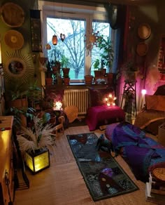 a living room filled with lots of furniture and plants in front of a large window