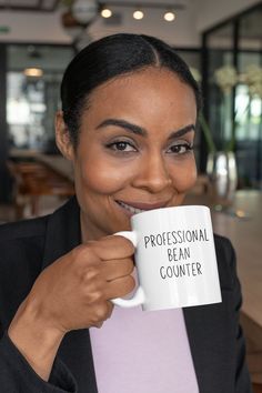 a woman holding a coffee mug in her hands