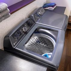 a washer and dryer sitting next to each other on top of a counter