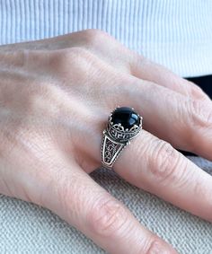 "This everyday use, lace embroidery minimalist 925 sterling silver filigree art crown cocktail ring has black onyx gemstone. The ring face is 0.47\" / 12.00 mm. Black Onyx gemstone is 10 mm, cabochon round-cut. Black Onyx gemstone is the mystical birthstone for December and astrological birthstone for Leo, would make the perfect option for a birthday gift, anniversary gift, thanksgiving gift, valentine's day gift, mother's day gift, to yourself or your daughter, sister, wife, grandma or girlfrie Gothic Silver Filigree Ring For Gifts, Black Sterling Silver Filigree Ring As A Gift, Ornate Black Sterling Silver Rings, Black Cabochon Jewelry For Wedding, Black Cabochon Wedding Jewelry, Elegant Adjustable Filigree Ring For Formal Occasions, Ornate Black Rings For Gifts, Ornate Black Rings As Gift, Ornate Black Rings For Gift