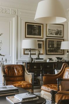 a living room filled with furniture and pictures on the wall