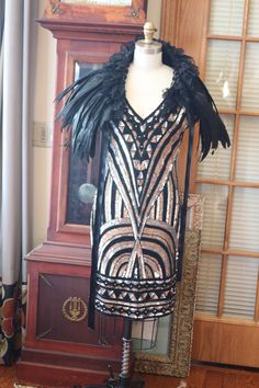 Black copper silver striking beaded pattern on this fabulous flapper dress! This is a stunner! If you want more length we could add a beaded fringe at the hemline. Accessories not included but available. Many more pics on fb: https://www.facebook.com/pg/RetroVintageWeddings1920s1930s/photos/?tab=album&album_id=2682673518495341 Black Embellished Flapper Dress, Black Fitted Gatsby Style Sequin Dress, Black Art Deco Dress For Costume Party, Black Art Deco Flapper Dress For Night Out, Black Art Deco Flapper Dress With Sequins, Black Sequined Art Deco Flapper Dress, Black Embellished Glamorous Flapper Dress, Black Gatsby Style Embellished Dress, Glamorous Black Embellished Flapper Dress