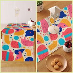 a table topped with a bowl of fruit next to a plate of cookies and cupcakes