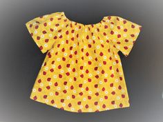 This handmade yellow ladybug baby toddler top will be adorable and comfy for your little girl. It will be great for special occasions, and durable for every day wear.    It is available in the flutter cap sleeve, or with short sleeves in sizes from 3 months up to 3 years.    --Made with high quality, breathable 100% cotton fabric --The fabric has been prewashed/preshrunk in clear water.  --It's a fun print with red ladybugs and white flowers on bright yellow background for a sweet little blouse that will be great for the warm days in spring, summer and fall.  -- It has elastic at the neckline for a comfortable fit, and easy dressing, and this style will fit your little girl for a long time.  -Easy Care: Cold water wash- No bleach, and dry on low heat, Can touch up with the iron. Matching L Cute Summer Blouse For Playtime, Cute Summer Playtime Blouse, Cute Cotton Blouse With Flutter Sleeves, Cotton Flutter Sleeve Tops For Playtime, Cute Flutter Sleeve Tops For Playtime, Cute Tops With Flutter Sleeves For Playtime, Cotton Tops With Flutter Sleeves For Playtime, Yellow Ladybug, Handmade Baby Gift