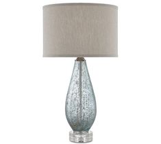 a glass table lamp with a white shade on top and a beige linen shade on the bottom