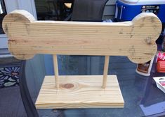 a wooden dog bone sitting on top of a glass table