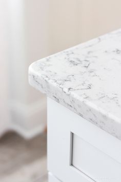 a white marble counter top in a bathroom