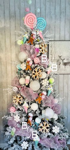 a decorated christmas tree in front of a wooden wall