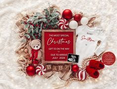 a baby's first christmas card surrounded by ornaments and other holiday items on a blanket