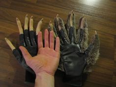 a person's hand with several claws on it