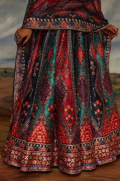 Multi color blouse with tribal print and threads, beads embroidery. Paired with coordinating lehenga and dupatta. - Aza Fashions Silk Bohemian Anarkali Set For Festivals, Bohemian Semi-stitched Traditional Wear For Ceremonies, Multicolor Traditional Wear For Transitional Season Ceremonies, Ceremonial Multicolor Dress With Dupatta, Unstitched Multicolor Sharara With Motifs, Unstitched Multicolor Motif Sharara, Bohemian Choli With Multicolor Embroidery And Pallu, Multicolor Traditional Wear With Motifs For Transitional Season, Bohemian Art Silk Sets For Navratri