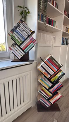 a stack of books sitting on top of a wooden stand